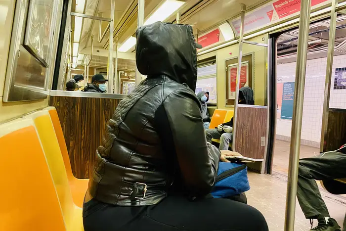 Inside a subway car on May 6, with passengers wearing masks and gloes